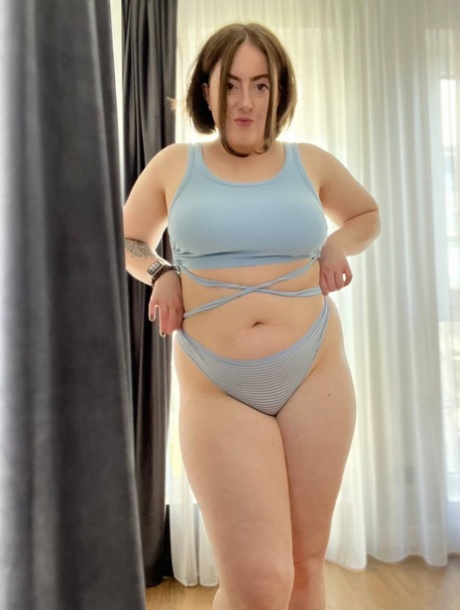 A picture of Kristi KKK, a model from OnlyFans and models for Chubby is taken while she shows off her big tits and wears her lingerie.