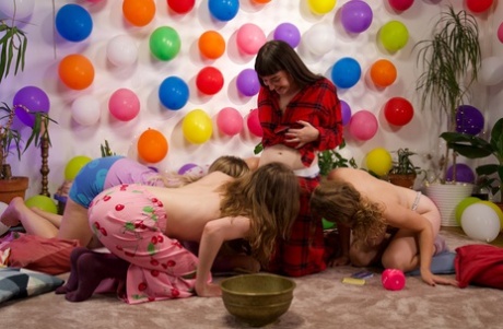 Horny amateur lesbians engage in an exuberant all-girl group sexual encounter.