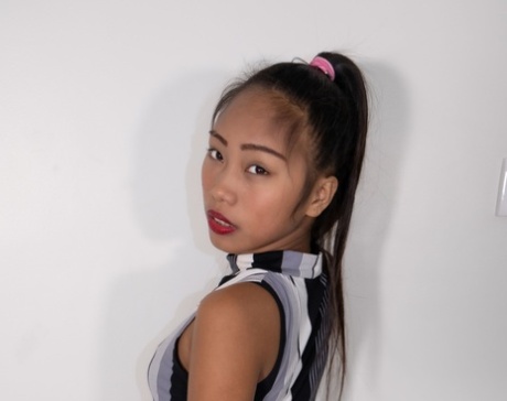 Attractive Asian teen Elisa	lifts her dress up & shows her ass in her panties