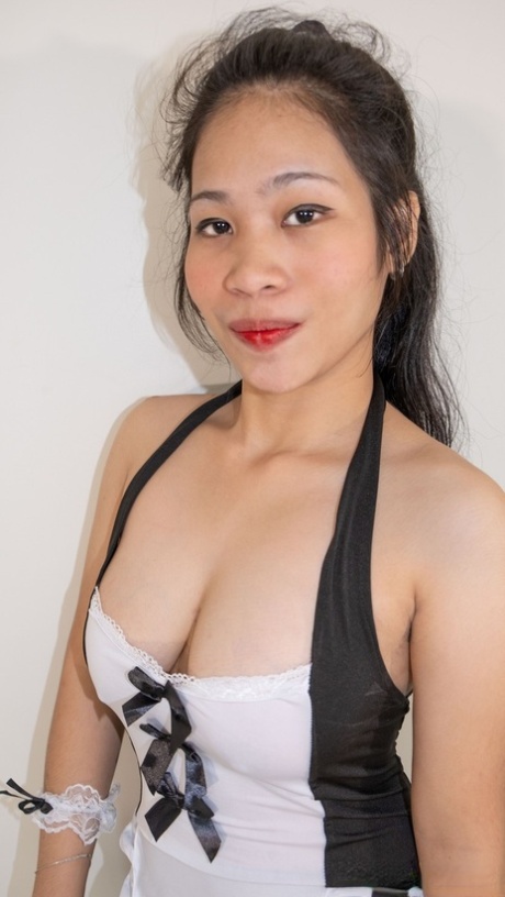 Chubby Asian maid Queenie poses with her big breasts unleashing in a solo performance.