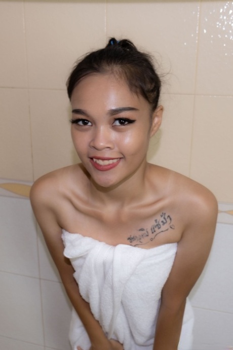 Asian hookers with tiny tits and a small body, Jenni poses for pictures in the bathroom while prostituting.