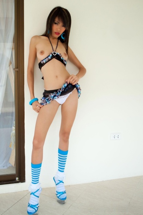 In her adorable socks and heels, Fai strips down to pose.