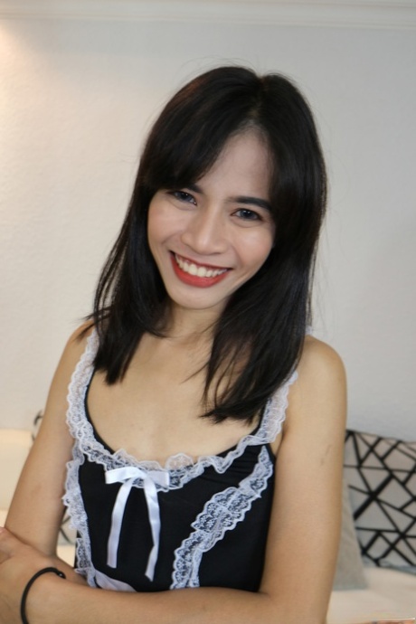 Parawisa, an Asian maid in the living room, displays her shaved head and tiny stools.