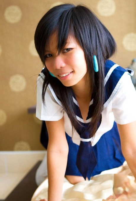 When Puy, an Asian schoolgirl, leaves her uniform undressed, she displays her slim physique.