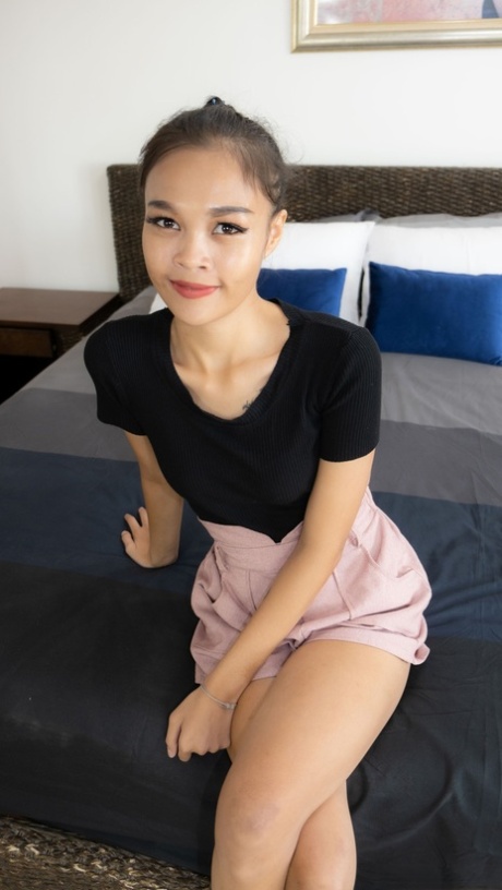 The beautiful Asian girl Jenni displays her shaved head and tiny breasts on stockings.