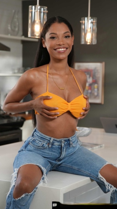 Busty ebony babe Eden West gives a big dick a wild ride in the kitchen