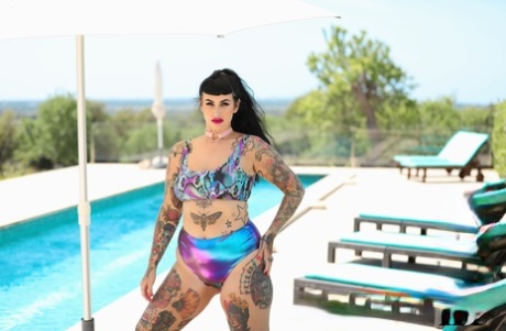 A tattooed and overweight individual named Cherrie Pie stripping naked in front of the pool.