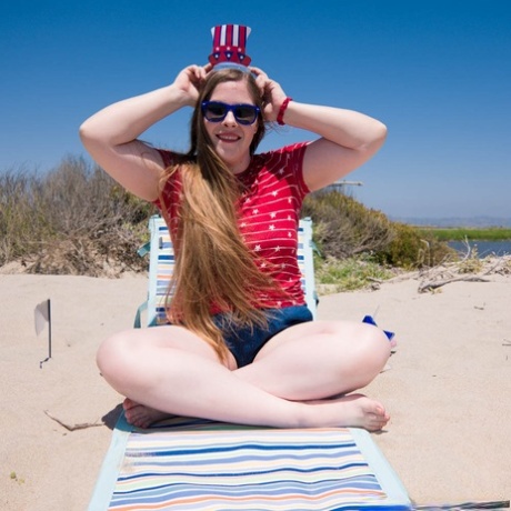 Chubby seductress Lana Del Lust exhibits her curve bump on a sandy beach.