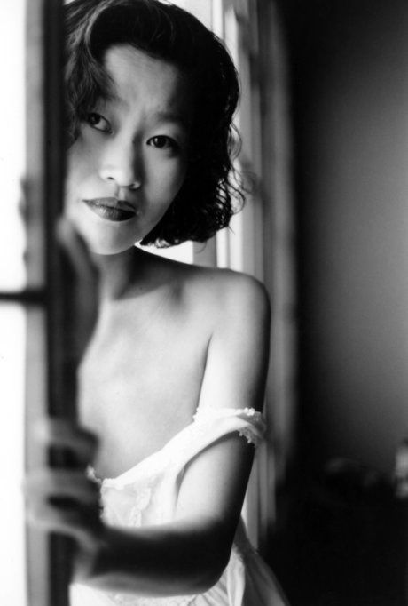 Asian babe shows her petite body & her tiny tits in a black & white scene