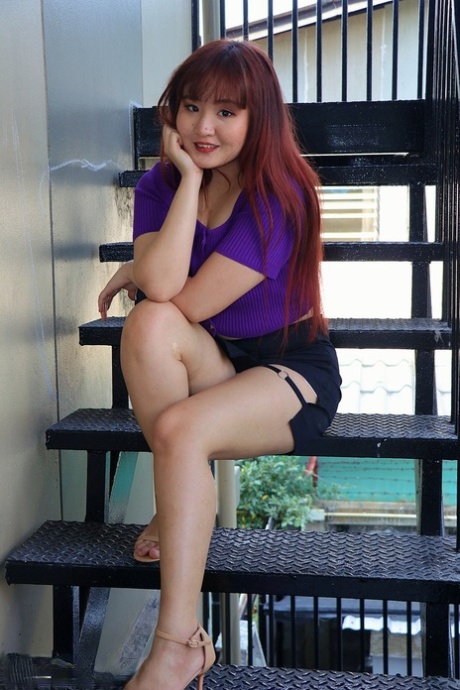 Redheaded Asian Beauty Poses On The Stairs In Her Hot Skirt & Purple Top