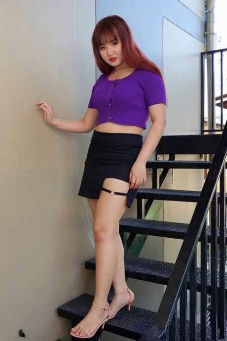 Redheaded Asian Beauty Poses On The Stairs In Her Hot Skirt & Purple Top