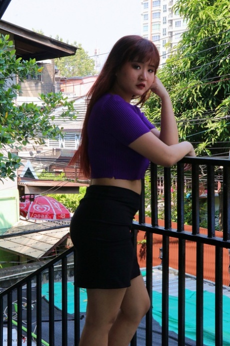 Redheaded Asian Beauty Poses On The Stairs In Her Hot Skirt & Purple Top