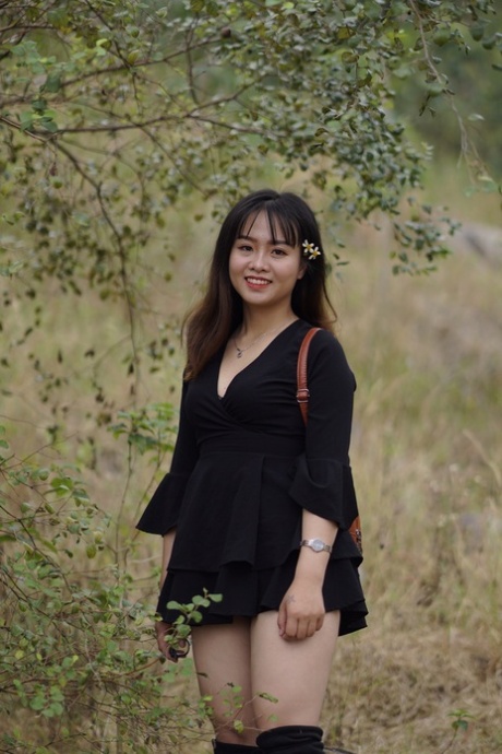 Gorgeous Asian Babe Posing In Her Black Dress And Boots In Nature