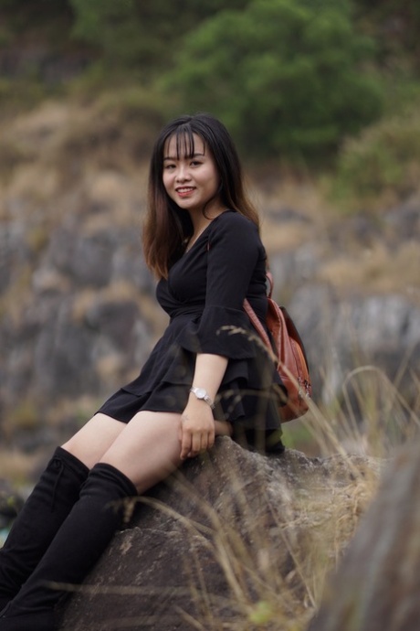 Gorgeous Asian Babe Posing In Her Black Dress And Boots In Nature