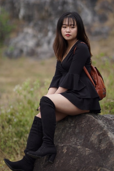 Gorgeous Asian Babe Posing In Her Black Dress And Boots In Nature