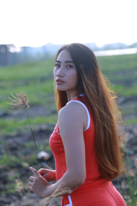 Attractive Asian Babe Posing Outdoors In Her Super Sexy Red Outfit