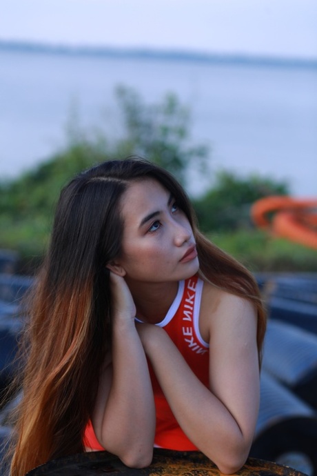 Attractive Asian Babe Posing Outdoors In Her Super Sexy Red Outfit