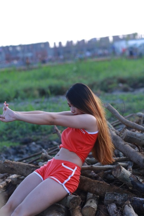 Attractive Asian Babe Posing Outdoors In Her Super Sexy Red Outfit