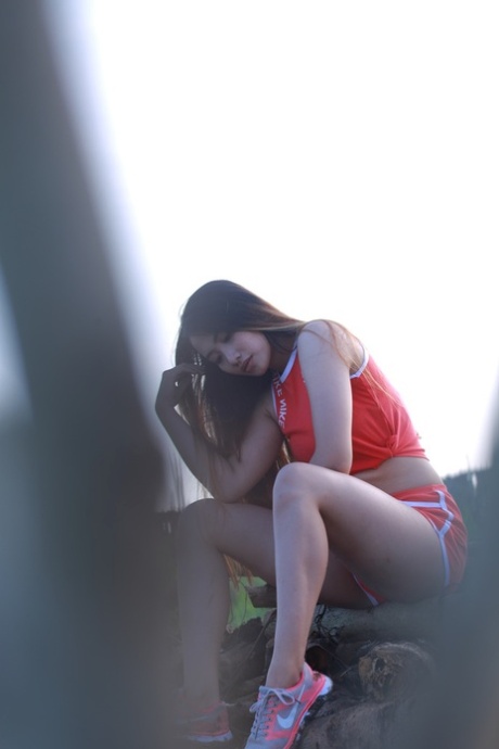 Attractive Asian Babe Posing Outdoors In Her Super Sexy Red Outfit