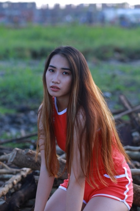 Attractive Asian Babe Posing Outdoors In Her Super Sexy Red Outfit