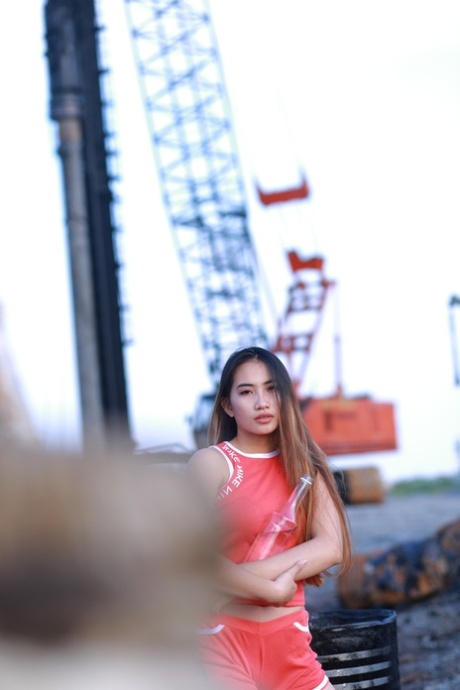 Attractive Asian Babe Posing Outdoors In Her Super Sexy Red Outfit