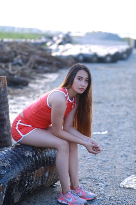 Attractive Asian Babe Posing Outdoors In Her Super Sexy Red Outfit