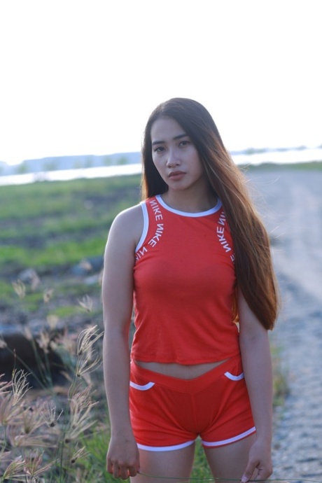 Attractive Asian Babe Posing Outdoors In Her Super Sexy Red Outfit