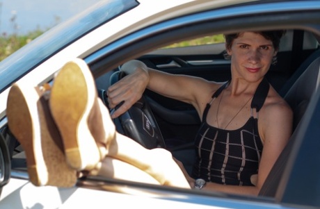 Short-haired Beauty Posing In Her Provocative Dress Next To Her Car Outside