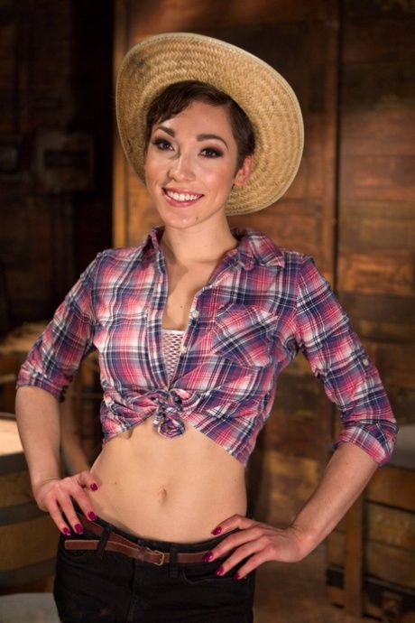 Lily LaBeau, a little girl with short hair, exposes her clothing and teases herself with her feet.