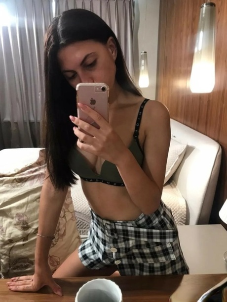 Teen goddess displays her vagina, squirting toiletries and hairless in the mirror.