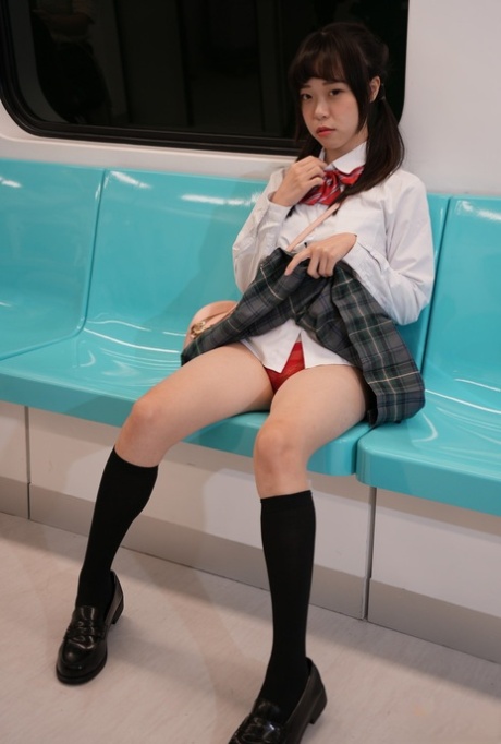 An Asian schoolgirl named Yuli had sexual intercourse with a senior on the train, doggystyle.