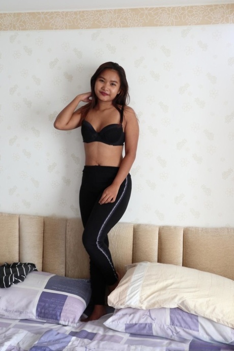 An Asian lady displays her lovely tits after taking off all the clothes for a bath.