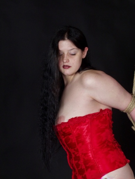 In rope bondage, a male handler secures Chubby brunette Emma with her.