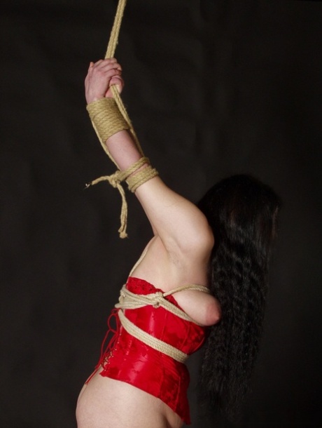 Chosy blonde Slavegirl Emma is given a male handler who performs rope bondage while holding her in the air.