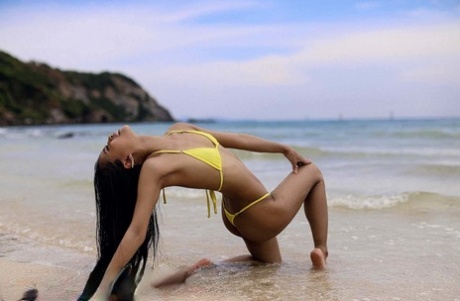 Attractive Asian Babe Posing In Her Sexy Yellow Bikini In A Solo