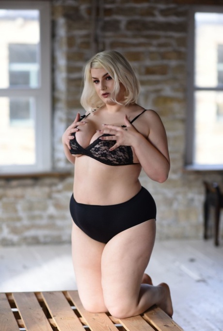 Despite her plump blonde locks, model Peaches flaunts her massive breasts while wearing only her top.