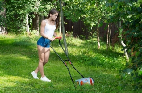 Teen in denim shorts Evelina Darling rubs her bush after mowing the yard