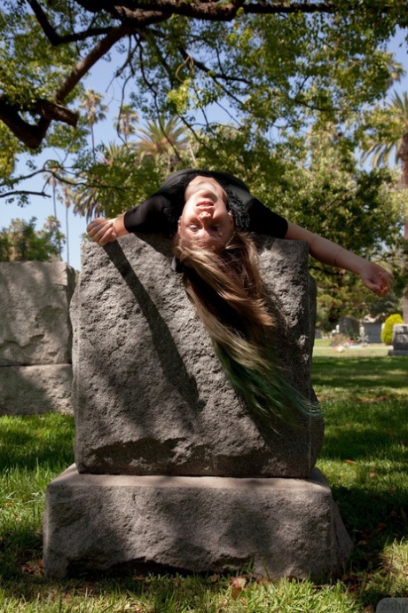 Naughty American teen Evelyn Bishop flashing an upskirt at the cemetery