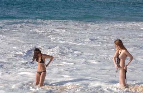 Playful: Faye & Larysa, left and right, are seen here on the beach stripping off in their bikinis.