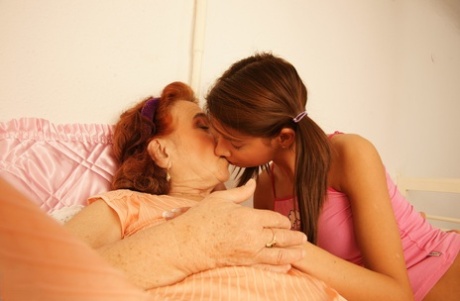 Petite lesbian teen Petrina licks a chubby granny's hairy pussy
