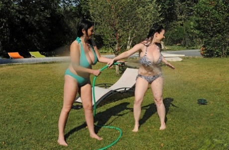 Busy Michelle Monaghan and Karina Heart enjoy themselves in the back yard without clothes on.