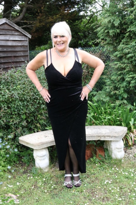 A fat, mature blonde named Christina is seen in her long dress and flaunting her cleavage.