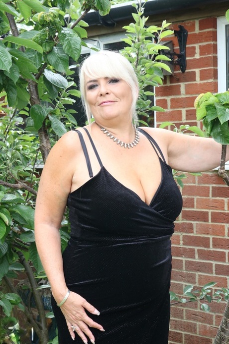 The picture of Christina, who is a fat and mature blonde with freckles on her body, shows her ingesting cleavage and wearing a long dress