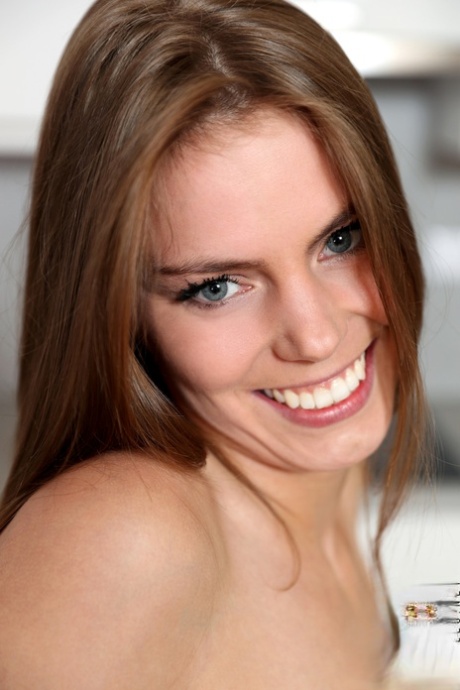 Slender teen Paula Pee exposes her pussy and toys it on the table