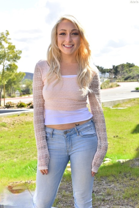 The attractive blonde teen, Valerie, teases in public with her belly button.