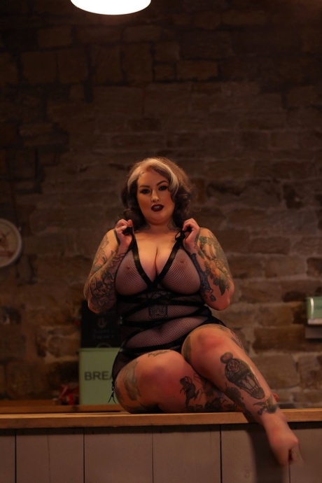 BBW tattooed Galda Lou is seen showing off her massive curves after losing all her lingerie.