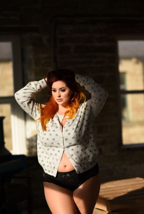 With her thick slacks, Lucy Vixen exposes her huge breasts and fastens up her panties.