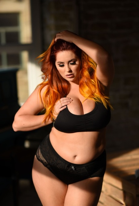 Lucy Vixen, the hefty model, exposes her huge breasts while touching her lace panty.