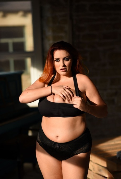 Lucy Vixen's thick model looks dashing in her lace panties and displays large breast implants.