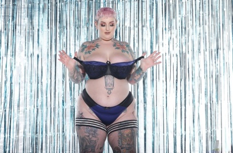 She displays monster tits and inked booties while stripping as the pink-haired BBW Cherrie Pie.